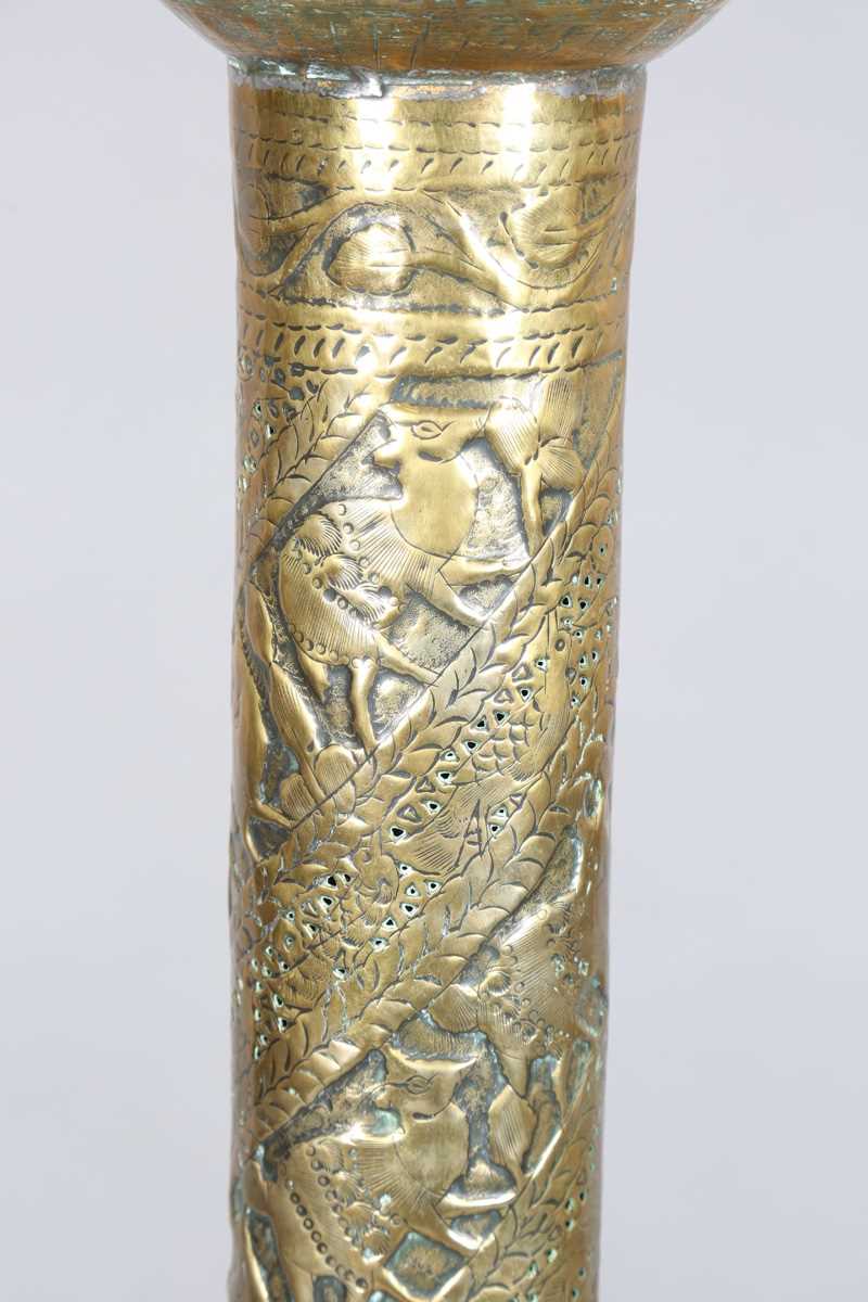 An Islamic brass floor lamp, circa 1900, the flared surmount and cylindrical column decorated with - Image 4 of 24