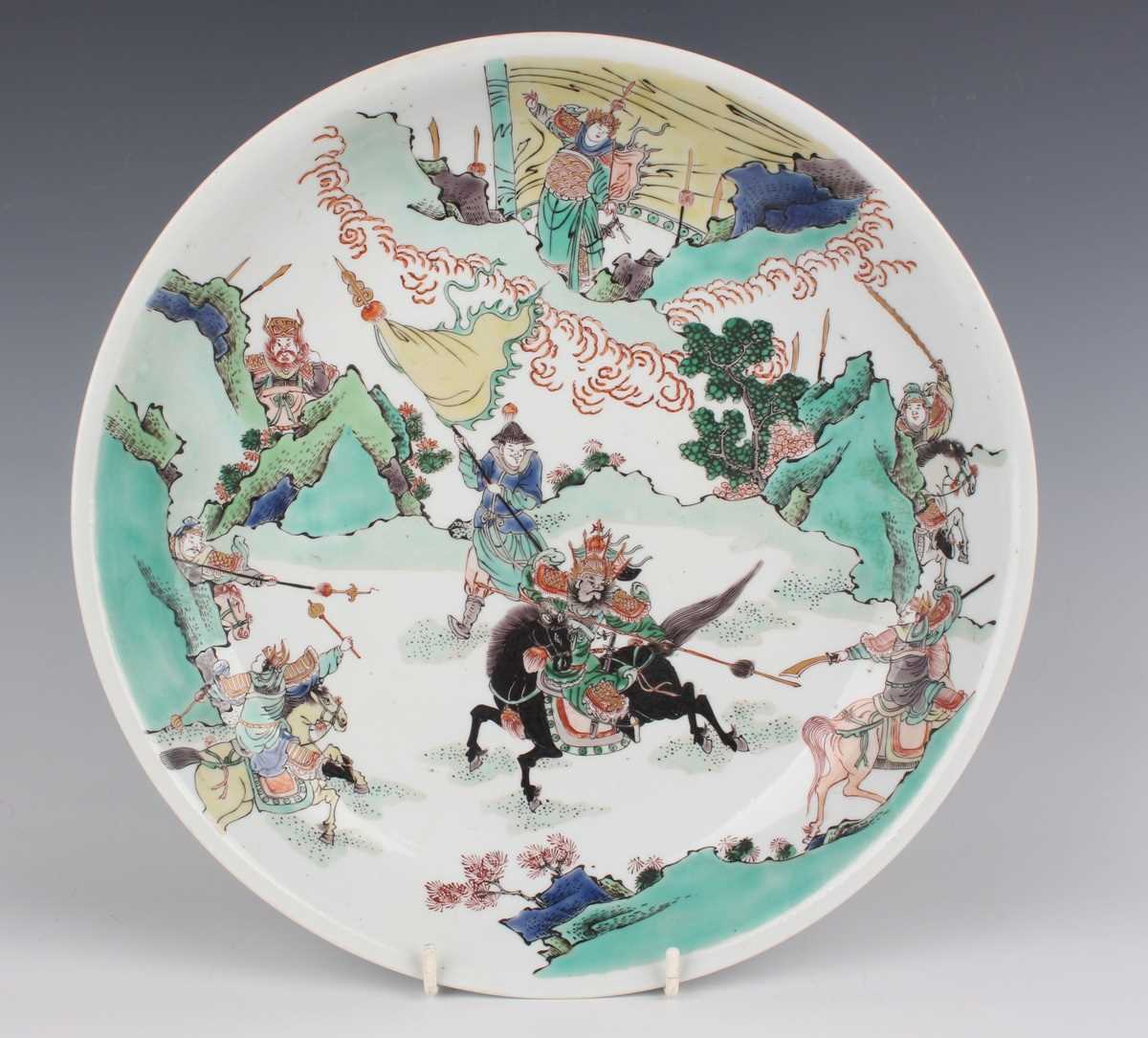 A Chinese famille verte porcelain saucer dish, Kangxi style but later, painted with a battle