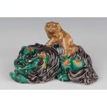 A Japanese Kutani porcelain figure group of a Buddhistic lion and cub, Meiji period, the green and