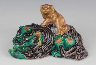 A Japanese Kutani porcelain figure group of a Buddhistic lion and cub, Meiji period, the green and