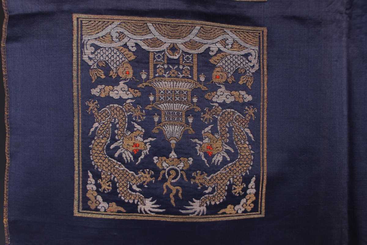 A Chinese blue silk embroidered rectangular panel, 20th century, worked with eight matching rank - Image 26 of 70