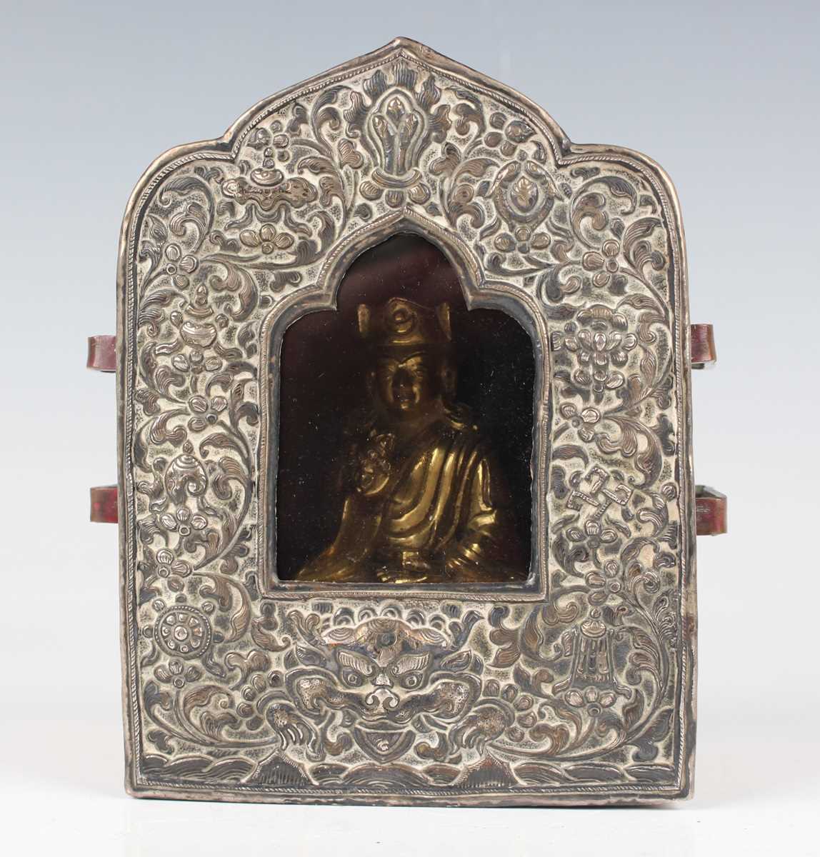 A Tibetan white metal mounted copper gau (portable shrine), late 19th century, the copper box of