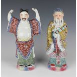 A pair of Chinese famille rose enamelled porcelain figures of immortals, 20th century, each modelled