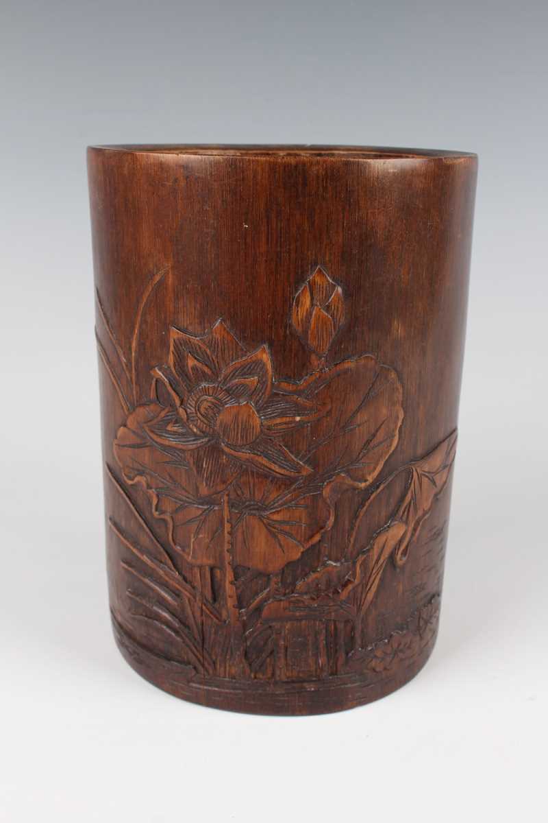 A Chinese bamboo brushpot, 20th century, the exterior carved in low relief with lotus opposing