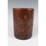 A Chinese bamboo brushpot, 20th century, the exterior carved in low relief with lotus opposing