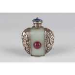 A Tibetan white metal mounted pale celadon jade snuff bottle, probably early 20th century, of