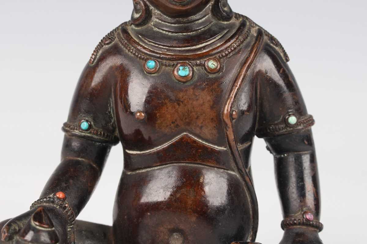 A Sino-Tibetan brown patinated copper alloy/bronze figure of Jambhala, late Qing dynasty, with - Image 3 of 8
