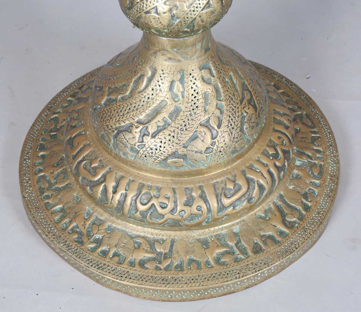 An Islamic brass floor lamp, circa 1900, the flared surmount and cylindrical column decorated with - Image 18 of 24