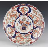 A Japanese Imari porcelain circular charger dish, Meiji period, typically painted and gilt with