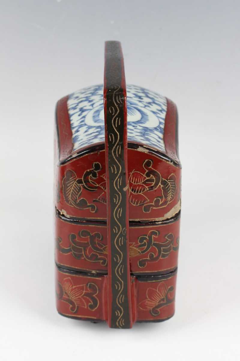 A Chinese red lacquer three-tier box with overhead handle, late 19th/early 20th century, decorated - Image 3 of 46