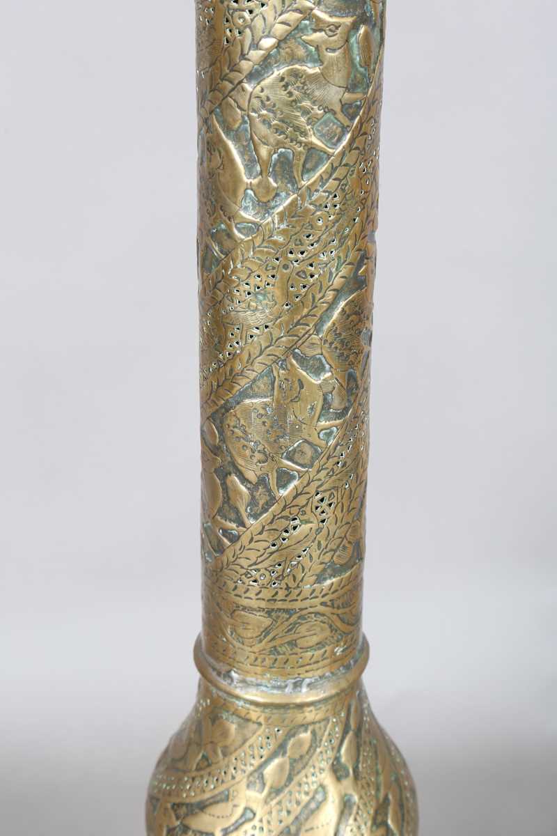 An Islamic brass floor lamp, circa 1900, the flared surmount and cylindrical column decorated with - Image 12 of 24