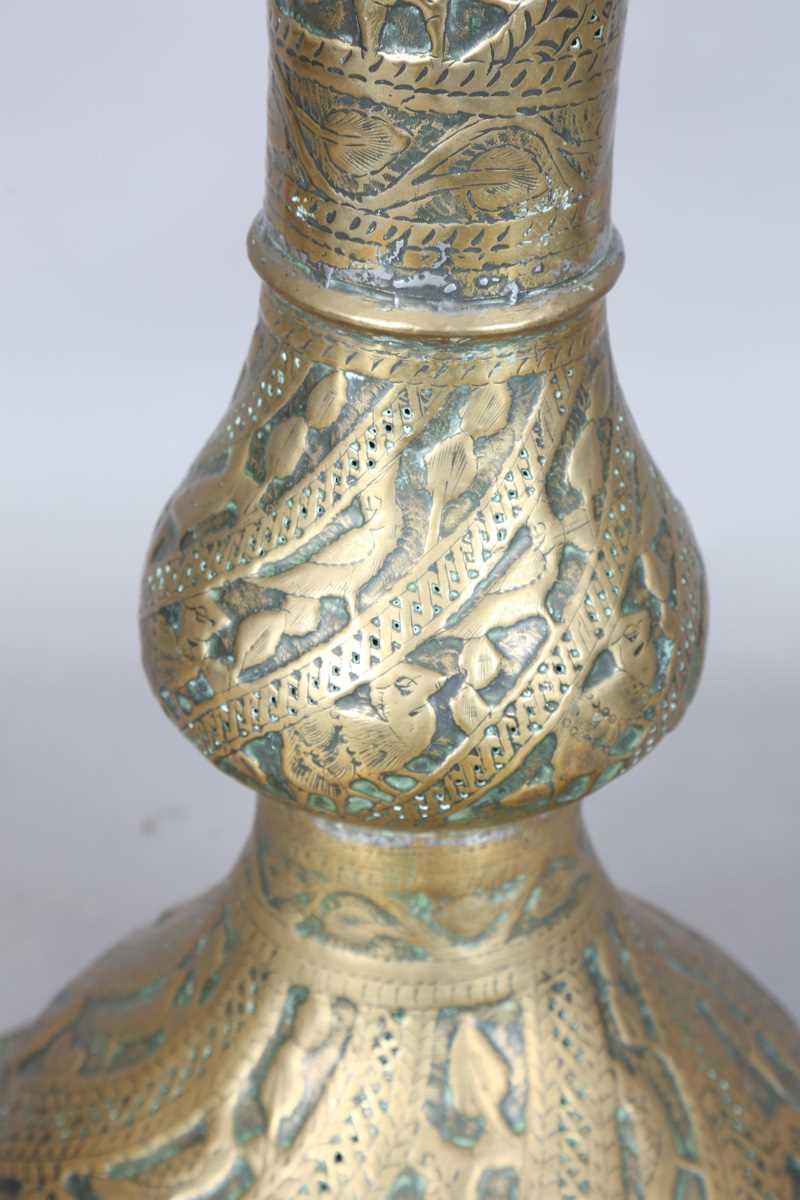 An Islamic brass floor lamp, circa 1900, the flared surmount and cylindrical column decorated with - Image 7 of 24