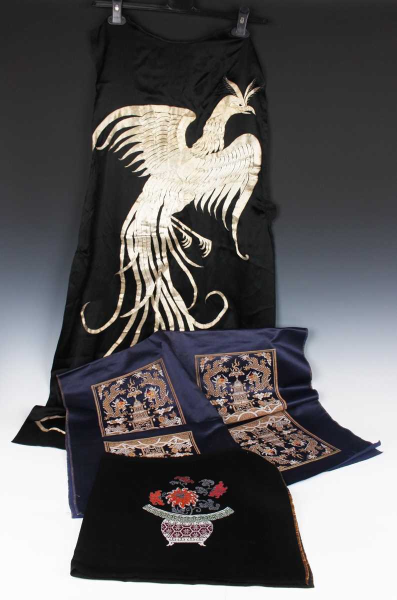 A Chinese blue silk embroidered rectangular panel, 20th century, worked with eight matching rank