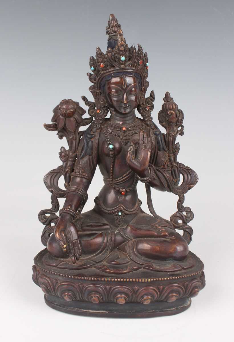 A Sino-Tibetan brown patinated copper alloy figure of Tara, 20th century, modelled seated in