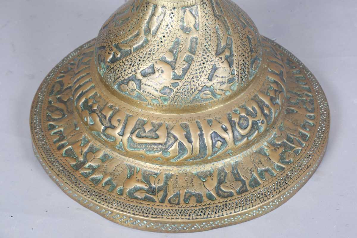 An Islamic brass floor lamp, circa 1900, the flared surmount and cylindrical column decorated with - Image 8 of 24