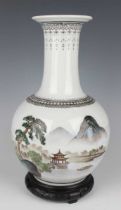 A Chinese porcelain bottle vase, Republic period or slightly later, the globular body painted with