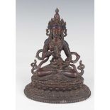 A Sino-Tibetan brown patinated copper alloy figure of Vajrapani, 20th century, modelled seated in