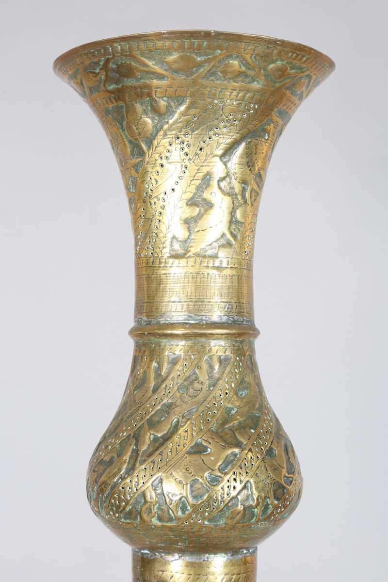 An Islamic brass floor lamp, circa 1900, the flared surmount and cylindrical column decorated with - Image 10 of 24