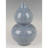 A Chinese Guan-type blue crackle glazed stoneware double gourd shaped vase, mark of Qianlong but