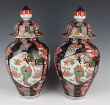 A pair of Japanese Imari porcelain vases and covers, Meiji period, each ovoid body and domed cover