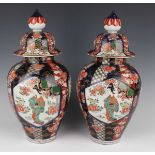 A pair of Japanese Imari porcelain vases and covers, Meiji period, each ovoid body and domed cover