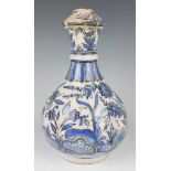 A Persian Qajar tin glazed earthenware bottle vase, 19th century, the ovoid body and girdled