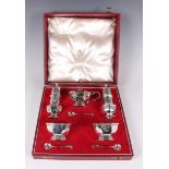 An Elizabeth II silver condiment set, comprising pair of pepper casters, pair of salts and mustard