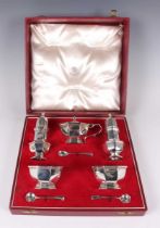 An Elizabeth II silver condiment set, comprising pair of pepper casters, pair of salts and mustard