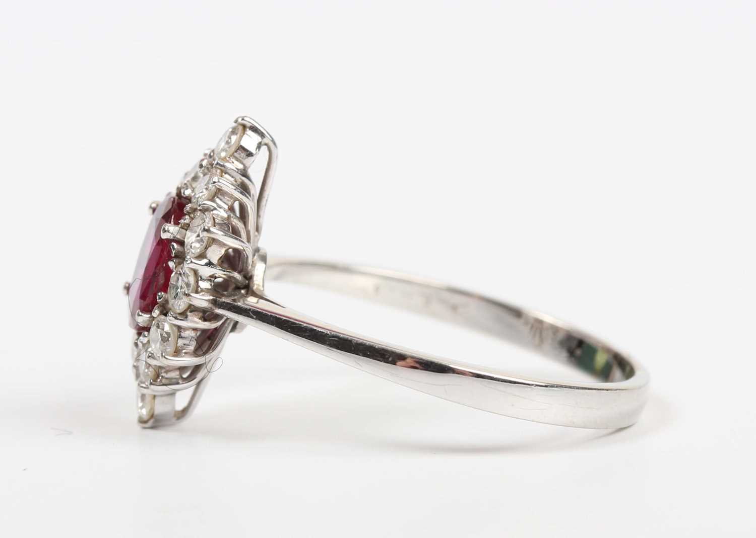 A ruby and diamond cluster ring, claw set with the oval cut ruby within a marquise shaped surround - Image 3 of 5