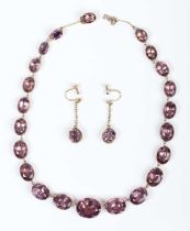 A Georgian gold and foil-backed mauve paste necklace, mounted with a row of graduated oval cut mauve