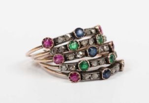A gold and silver set, diamond and varicoloured gem set five band ring, each band mounted with pairs