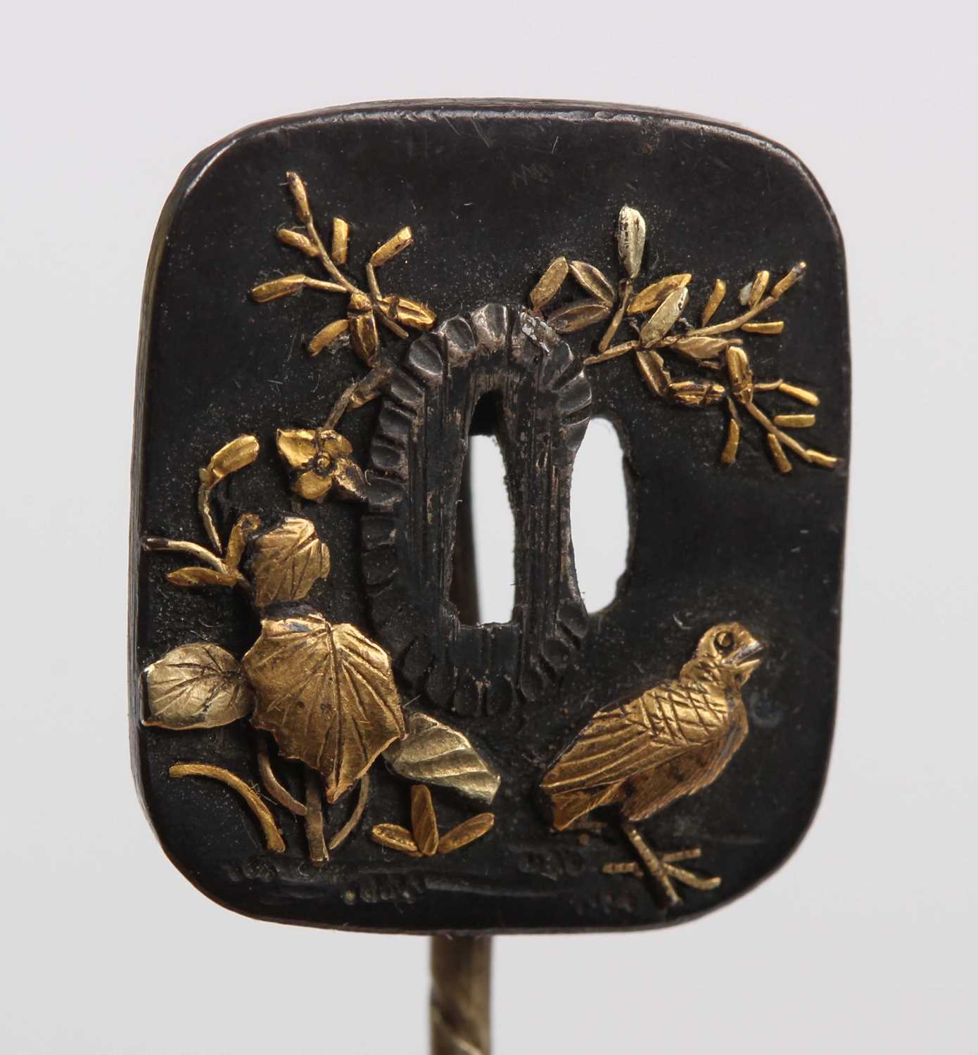 A Japanese miniature tsuba, decorated in relief with a bird and foliage, picked out in gilt - Image 2 of 5