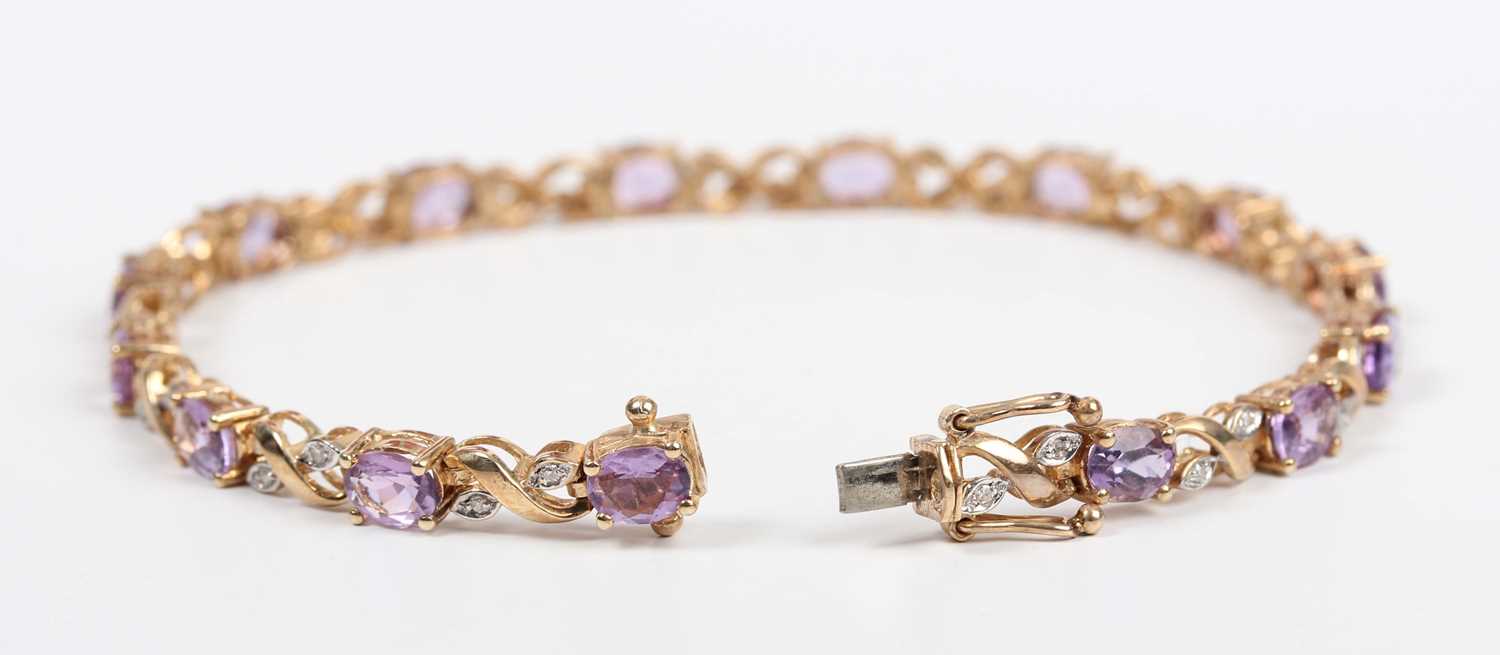 A gold, amethyst and diamond bracelet, claw set with a row of oval cut amethysts alternating with - Image 2 of 3