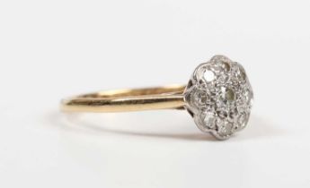 An 18ct gold and diamond nine stone cluster ring, mounted with the principal circular cut diamond to