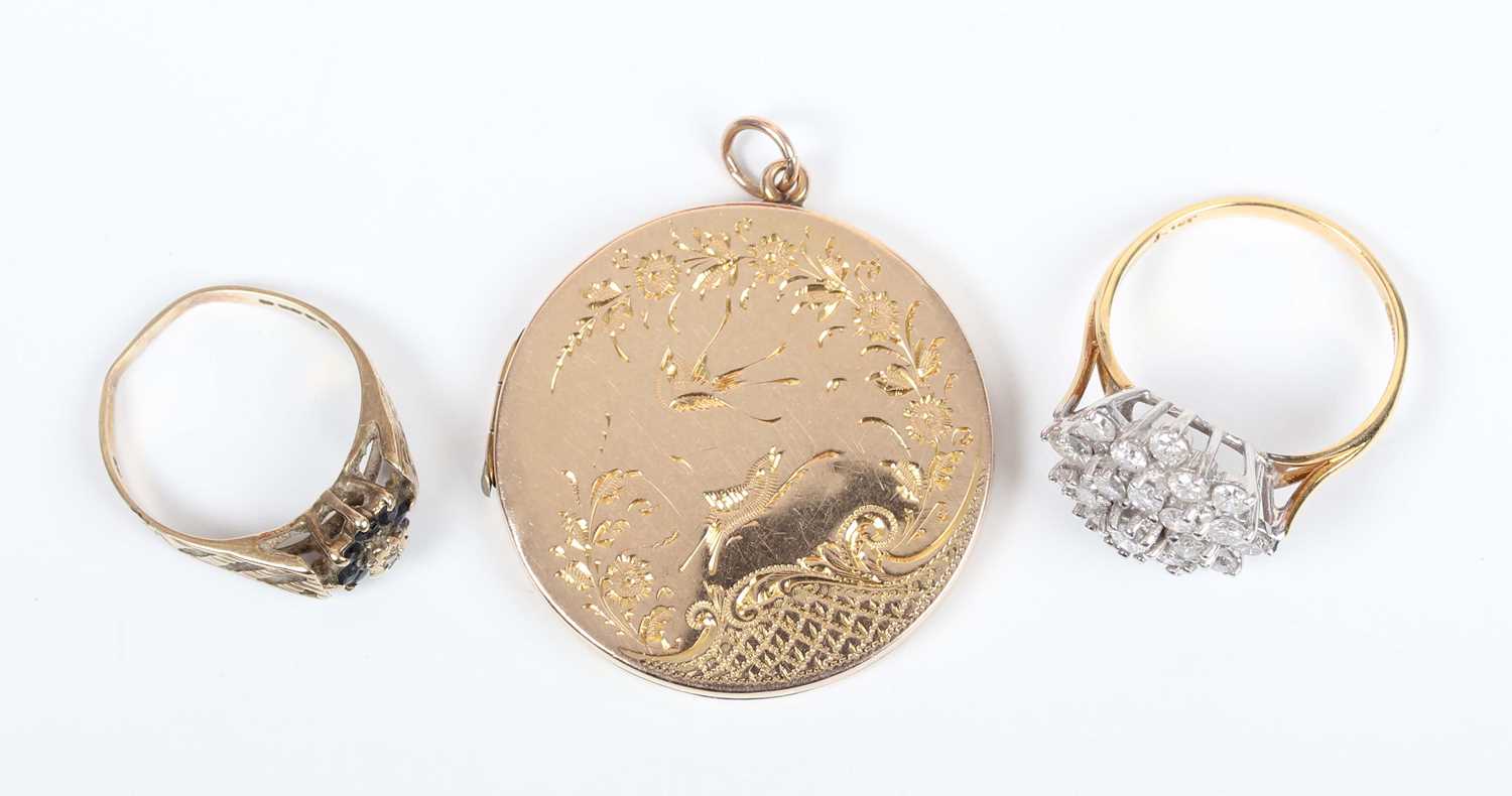 A gold back and front circular pendant locket, decorated with birds and floral sprays, detailed ‘9ct