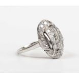 A diamond oval cluster ring in a panel shaped design, mounted with circular cut diamonds, the