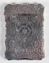 A Victorian silver rectangular card case, the front engraved with a crest within a buckle and