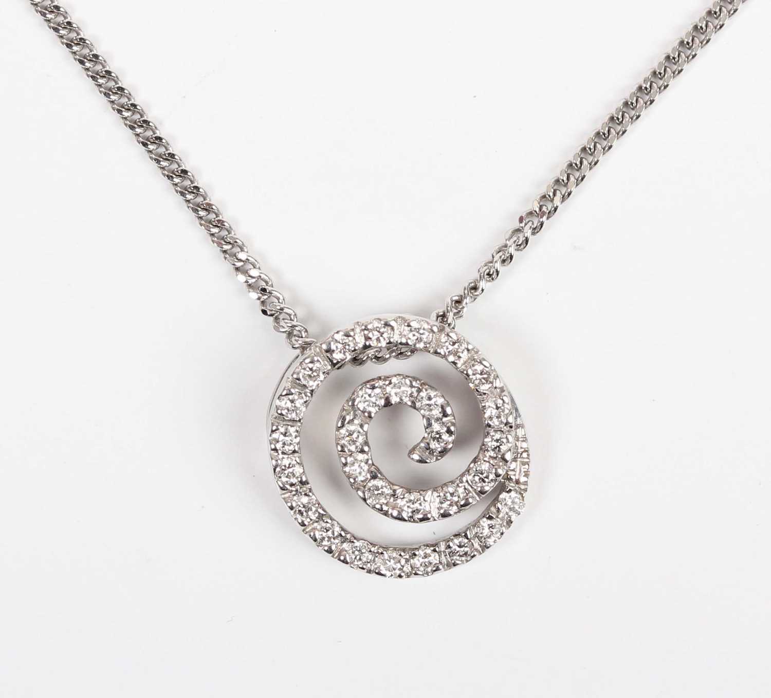 An 18ct white gold and diamond pendant in a coiled design, mounted with a circular cut diamond,