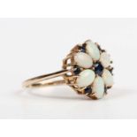 A 9ct gold, opal and sapphire cluster ring, mounted with the principal circular cut sapphire