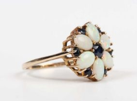 A 9ct gold, opal and sapphire cluster ring, mounted with the principal circular cut sapphire