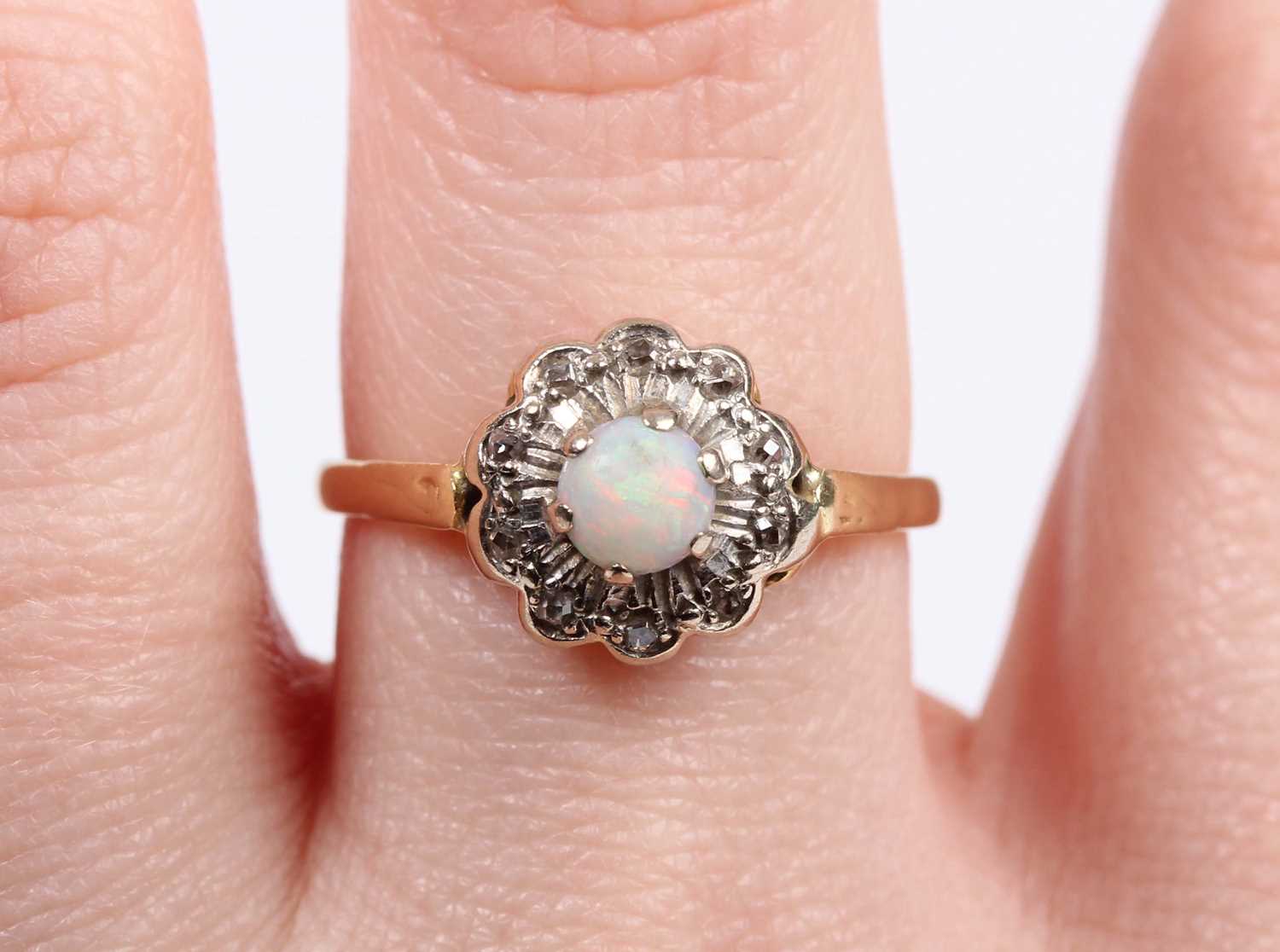 A gold, opal and diamond cluster ring, claw set with the circular opal within a diamond set - Image 5 of 5
