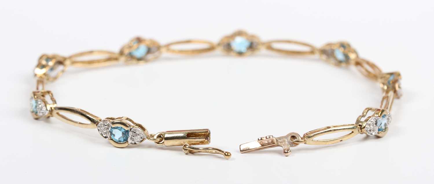 A 9ct gold, diamond and treated blue topaz bracelet, mounted with a row of circular cut treated blue - Image 2 of 3