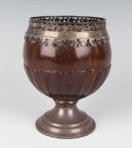 A George III plate mounted coconut cup, the rim cast and pierced with a band of flowers and
