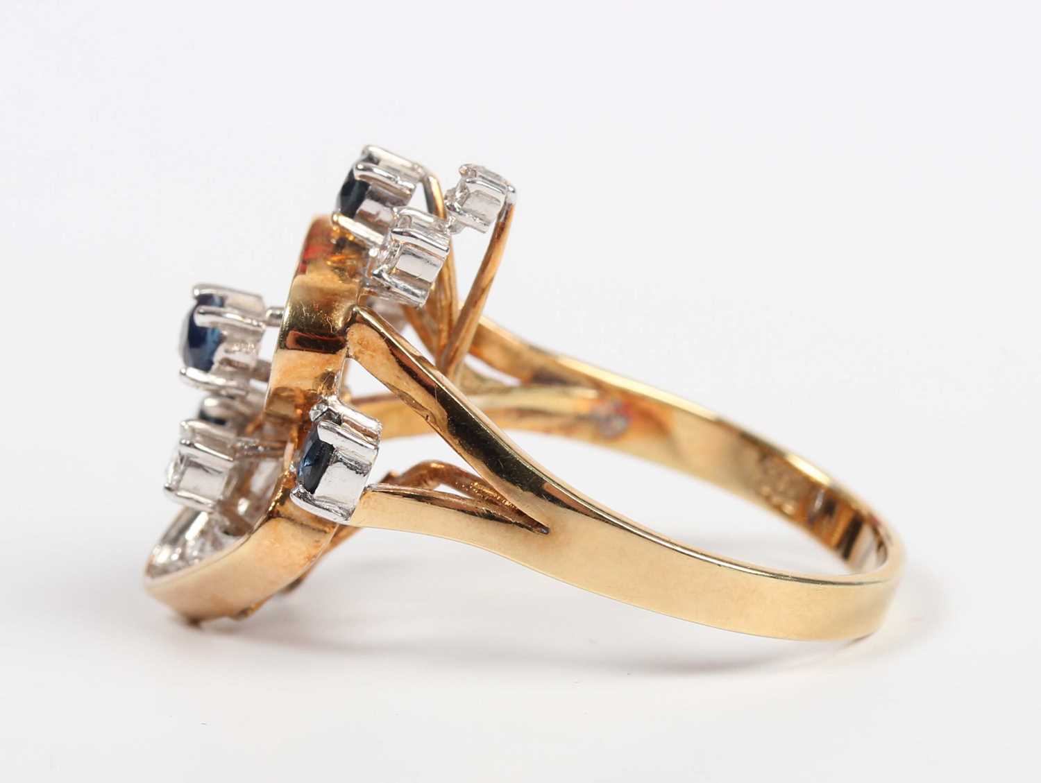 A gold, sapphire and diamond ring in an abstract design, claw set with five circular cut - Image 3 of 5