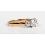 An 18ct gold and diamond three stone ring, claw set with old cut diamonds, the principal diamond