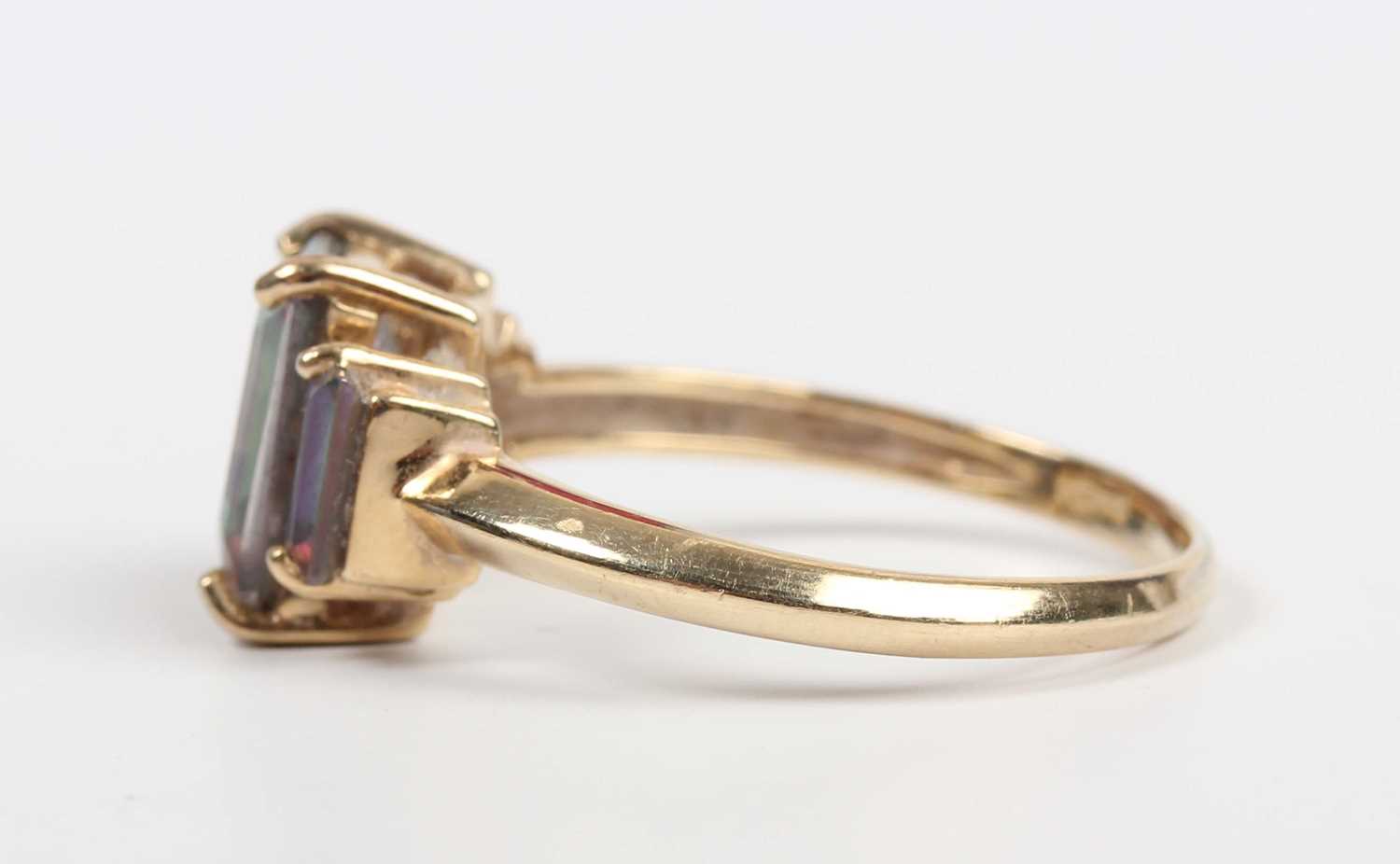 A 9ct gold ring, mounted with a cut cornered rectangular step cut mystic topaz between two smaller - Image 3 of 5