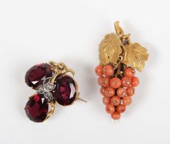 A gold, garnet and diamond pendant brooch in a trefoil shaped design, with a central rose cut