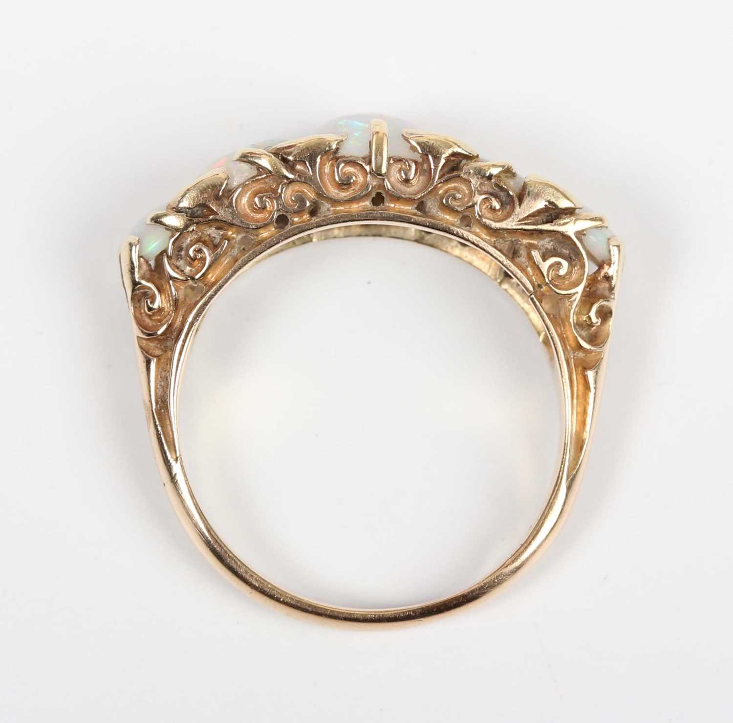 A gold, opal and diamond ring, mounted with a row of five graduated circular opals with four pairs - Image 4 of 5
