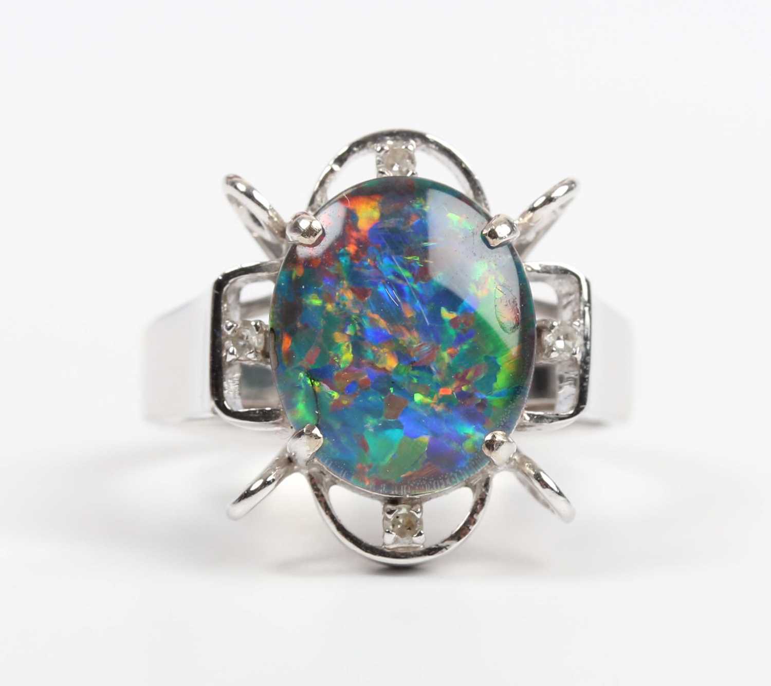 A white gold, opal triplet and diamond ring, claw set with the oval opal triplet in an openwork - Image 2 of 5
