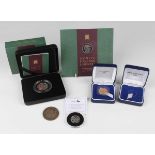 An Elizabeth II sovereign 2000, within a presentation box, and an empty presentation box for a